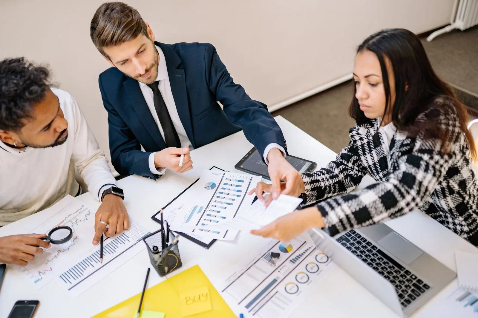 Small nonprofit staff reviewing grant documents together at a table
