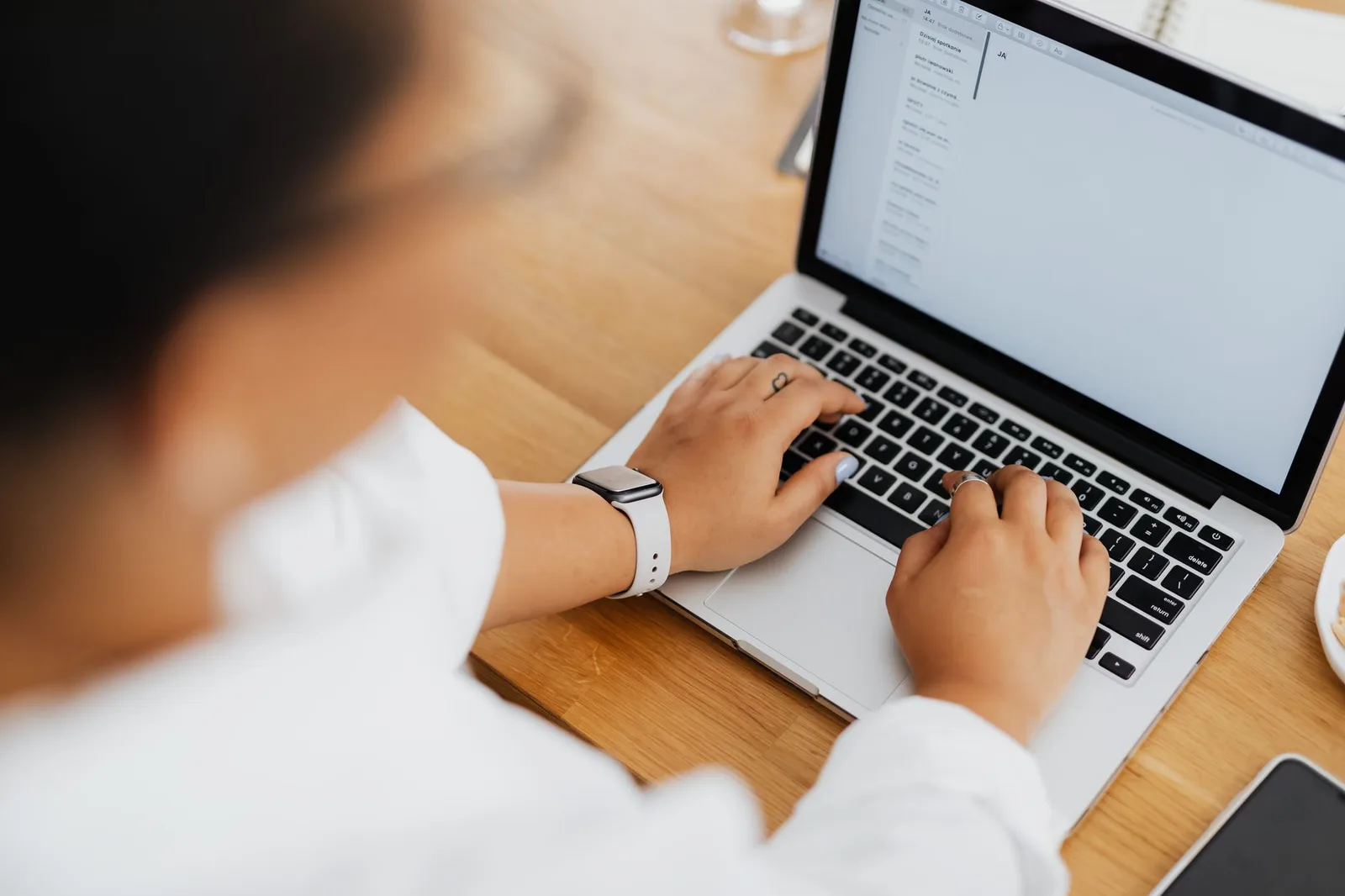 Nonprofit staff member writing donor emails on a laptop at a desk