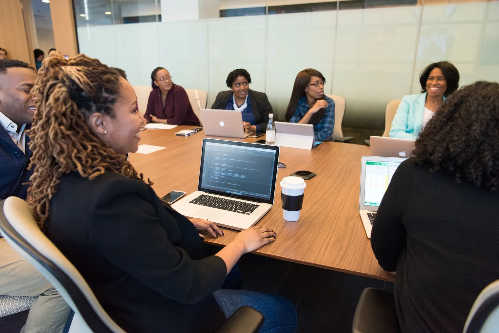 Two nonprofit staff members reviewing donor retention numbers on a laptop at a table