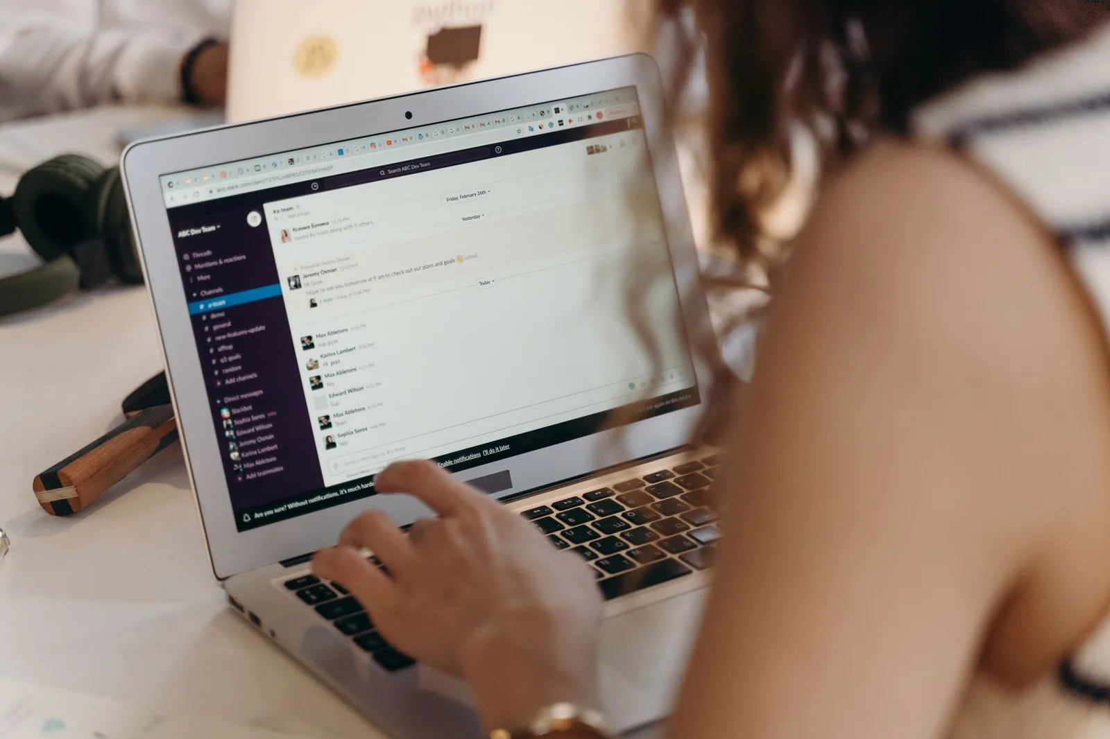 Two nonprofit staff members reviewing a donor email welcome series on a laptop in an office