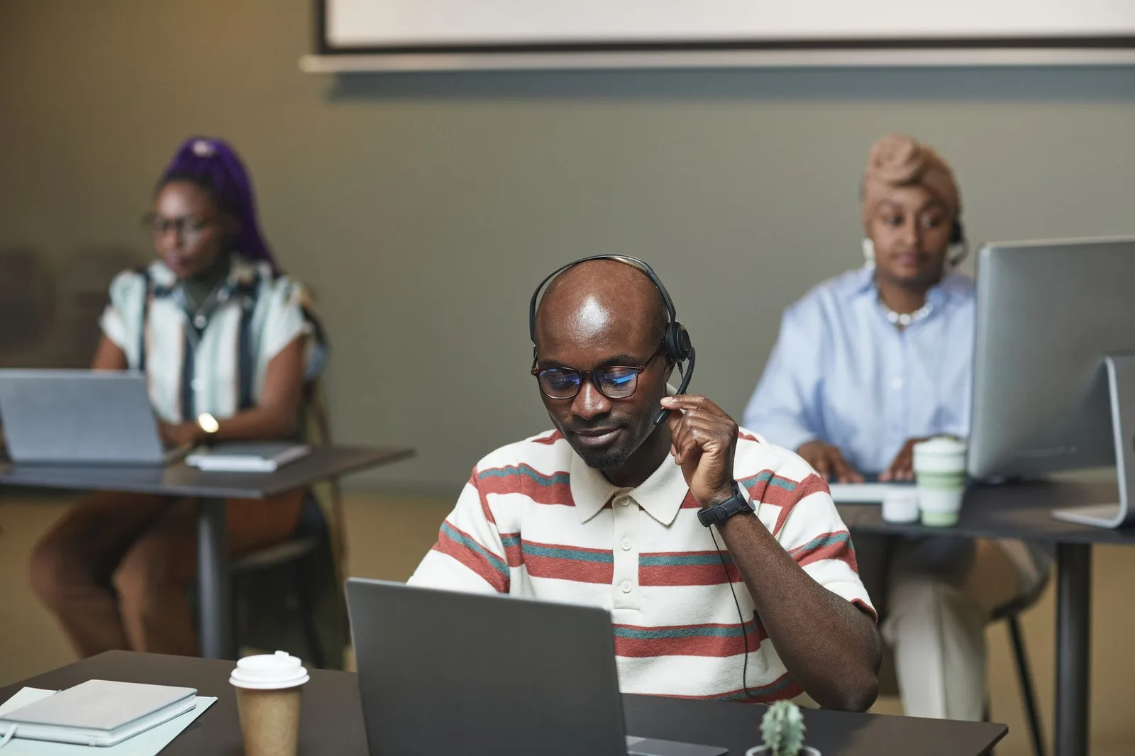 Two nonprofit team members reviewing donor records on a laptop during a platform migration